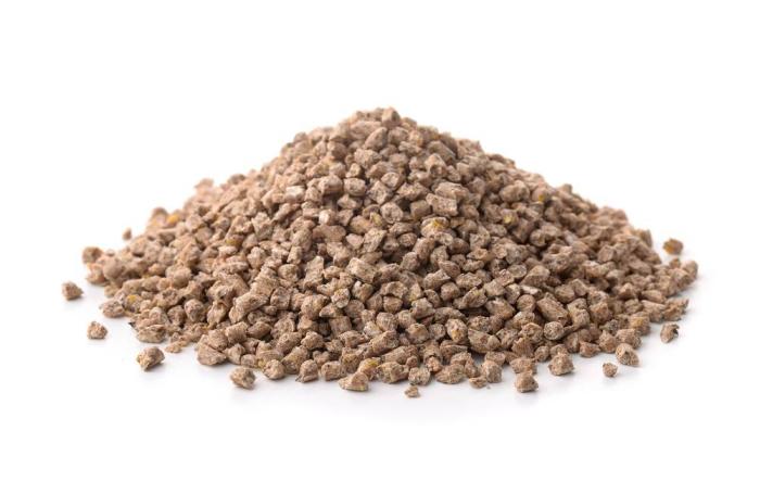 Pile of compound feed pellets isolated on white